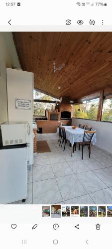 a kitchen and dining room with a table and chairs at Sitio CANTOS DA FLORESTA in Mairinque