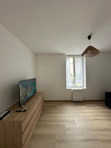 a white room with a table and a window at Studio des Combes in Le Creusot