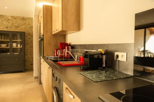 a kitchen with a black counter top with a appliance at Domaine Saint Thomas in Argelès-sur-Mer