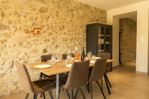 a dining room with a wooden table and chairs at Domaine Saint Thomas in Argelès-sur-Mer