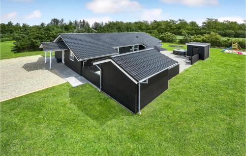 an overhead view of a black building on a grass field at Cozy Home In Tarm With Sauna in Tarm