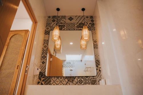 a bathroom with a mirror and a sink at Brandon Villa Lovina with Private Pool in Lovina