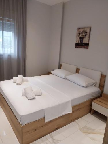 a bedroom with a large bed with two pillows on it at LUXURY Stay By the Beach in Neoi Epivates