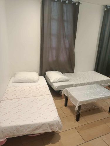 une chambre avec trois lits et une fenêtre dans l'établissement Mer, à Avignon