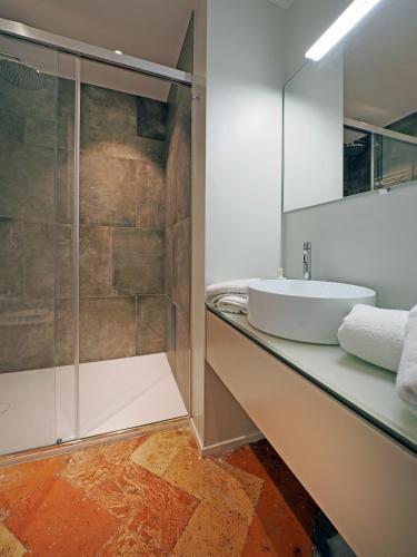 a bathroom with a sink and a shower at Appartamento Moon and Stars 7 in Muralto