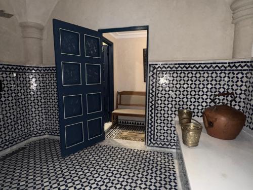 a room with a blue door and a chair at Riad Al-Qurtubi in Tangier
