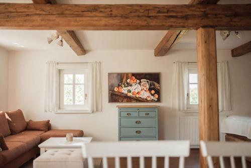 a living room with a couch and a painting on the wall at Bohdašín 17 in Červený Kostelec