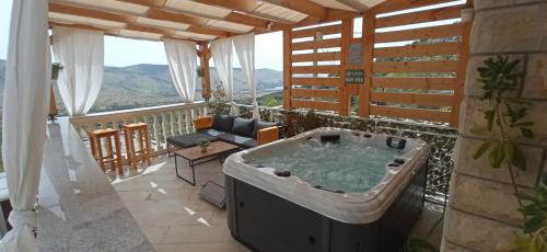 a room with a hot tub on a balcony at Holiday Home Peran in Grebaštica