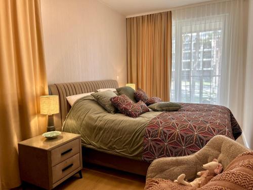 a small bedroom with a bed and a window at Apartamenty Bryza nad jeziorem in Augustów