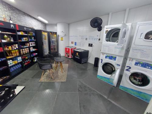 a laundry room with two washing machines and a washer and dryer at Book Santos - Unlimited 901 - Frente Mar com Vista Panorâmica in Santos