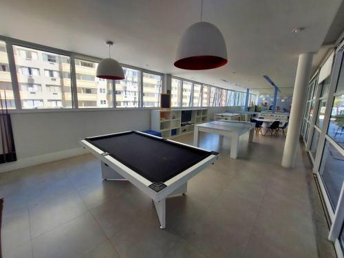 a room with a pool table in a building at Book Santos - Unlimited 901 - Frente Mar com Vista Panorâmica in Santos