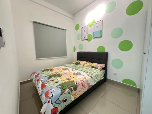 a bedroom with a bed with a comforter on it at 马六甲 Melaka Amber cove residence Jonker Street in Melaka