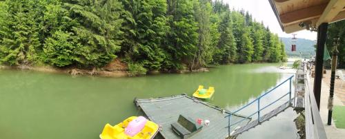 a river with two yellow boats on a dock at Simply zen in Colibiţa