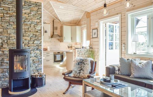 a living room with a stone wall and a fireplace at Tokagjelet in Norheimsund