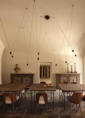 a room with tables and chairs and lights at Dimora Santagatha in Noto