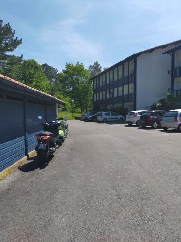 une moto garée dans un parking à côté d'un bâtiment dans l'établissement marie, à Anglet