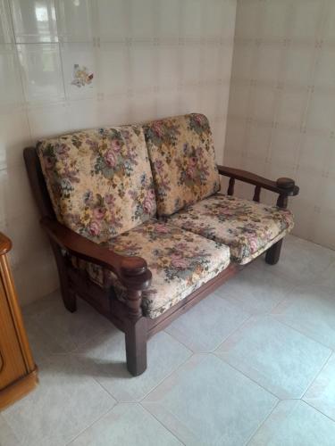 a couch sitting in a corner of a room at "SHARDANA" CASA VACANZe in Gonnesa