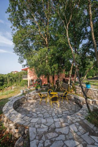 a patio with chairs and tables on a stone patio at Oasis of Peace Meterizi in Cetinje