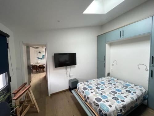 une chambre avec un lit et une télévision à écran plat dans l'établissement Maison neuve t4 Toute équipée piscine chauffé, à Nieul-sur-Mer