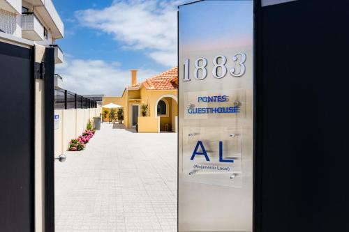a door with a sign for a house with a sale at Pontes Guest House in Arcozelo