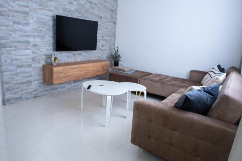 a living room with a couch and a table at Apartment Milla in Tomislavgrad