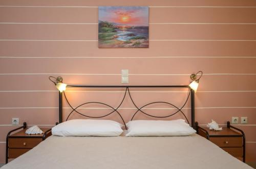 a bedroom with a bed with two white pillows at Orama Studios in Agia Anna Naxos