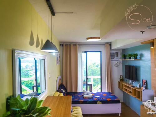 a small room with a bed and a window at Summer10th Pinesuites Scandi Minimalist Deluxe in Tagaytay