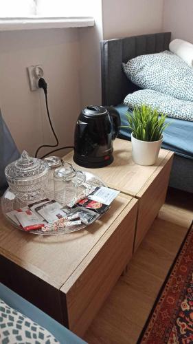 a coffee table in a bedroom with a bed and a table with a telephone at Centrum2a Łódź Próchnika 21 in Łódź