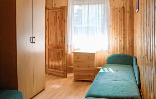 a living room with a green couch and a window at Nice Apartment In Kopalino With Wifi in Kopalino