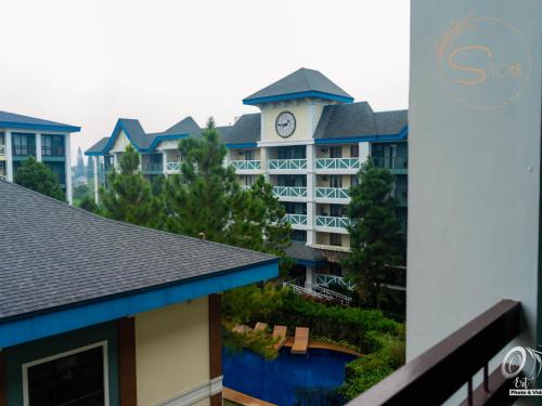 a view of a hotel with a clock tower at Summer10th Pinesuites Scandi Minimalist Deluxe in Tagaytay