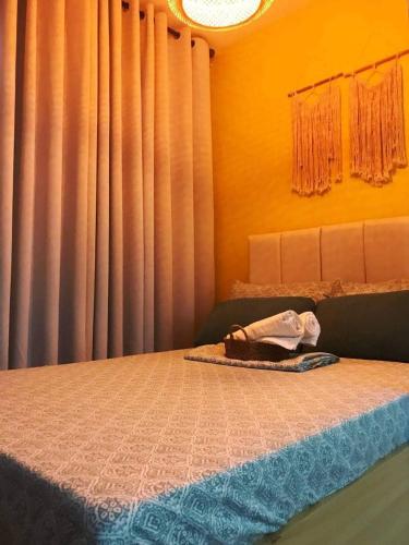 a bedroom with a bed with a window with curtains at Summer10th Pinesuites Scandi Minimalist Deluxe in Tagaytay