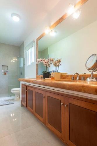 a bathroom with a large sink and a toilet at Stunning condo in excellent location in Cancún