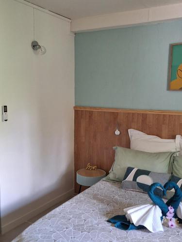 a bedroom with a bed with a blue wall at Jasmyna in Sans Pareil