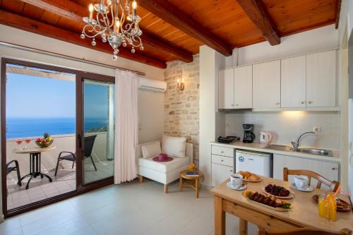 a kitchen with a table and a dining room at Stefanos Village Hotel in Plakias