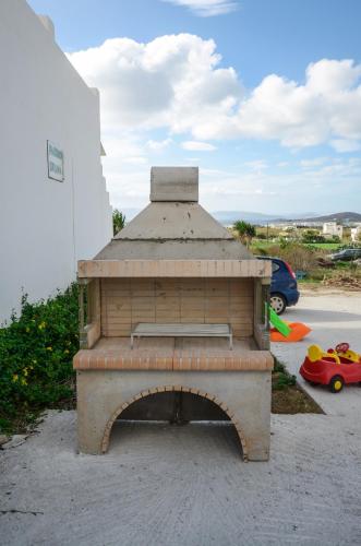 an outdoor brick oven in a parking lot at Orama Studios in Agia Anna Naxos