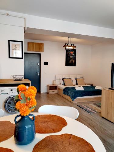 a living room with a bed and a table at Studio President 52 in Craiova
