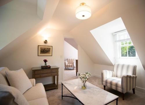 a living room with a couch and chairs and a table at Cleftstone Inn in Bar Harbor