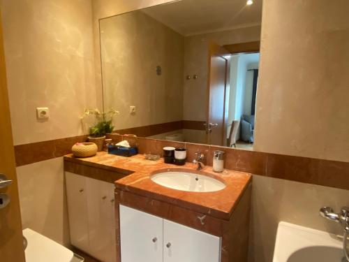 a bathroom with a sink and a large mirror at Lisbon NH HomeVipNobel - Luxurious apartment in Lisbon