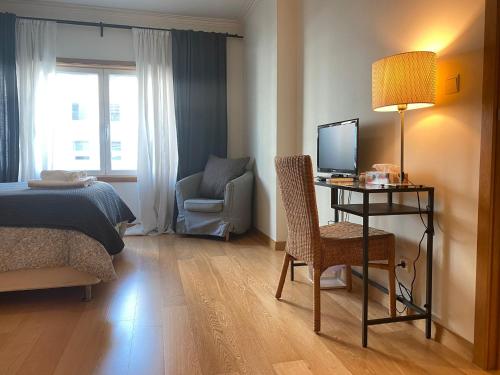 a bedroom with a bed and a desk with a computer at Lisbon NH HomeVipNobel - Luxurious apartment in Lisbon