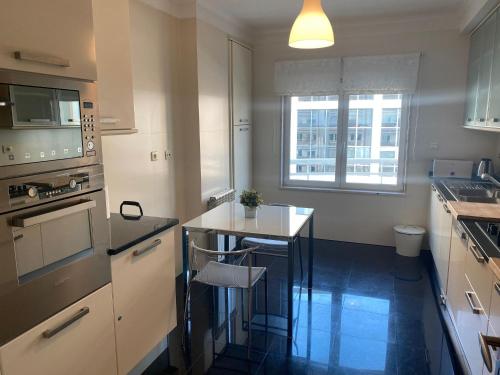 a kitchen with a small island in the middle at Lisbon NH HomeVipNobel - Luxurious apartment in Lisbon