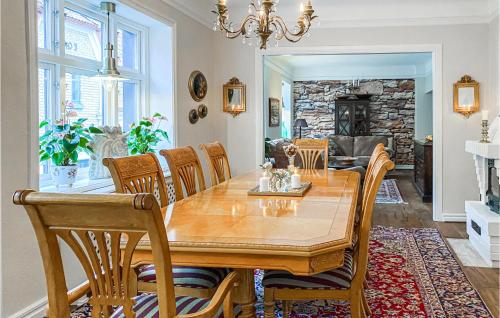 a dining room with a wooden table and chairs at 2 Bedroom Nice Home In Ystad in Ystad
