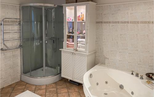 a bathroom with a shower and a bath tub at 2 Bedroom Nice Home In Ystad in Ystad