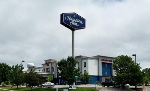a sign for a shopping center in front of a building at Hampton Inn Coldwater in Coldwater