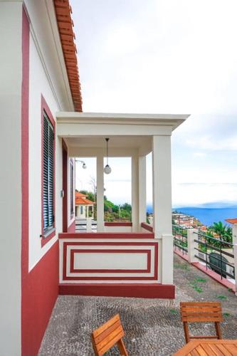 a balcony of a house with a view of the ocean at Renovated Traditional House w 3BR & Outdoor Space in Funchal