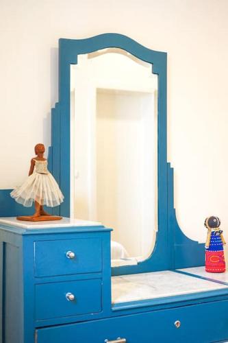 a blue dresser with a mirror on top of it at Renovated Traditional House w 3BR & Outdoor Space in Funchal