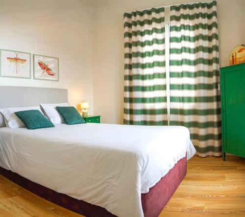 a bedroom with a large white bed and a window at Renovated Traditional House w 3BR & Outdoor Space in Funchal