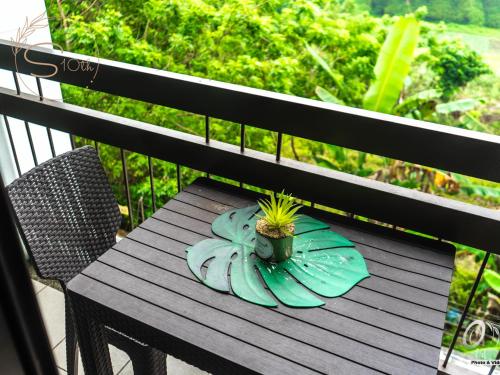 a plant in a pot on a table on a balcony at Summer10th Pinesuites Scandi Minimalist Deluxe in Tagaytay