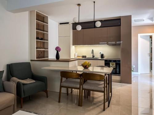a kitchen with a dining room table and chairs at ChillOut apartment in Kotor Bay in Kotor