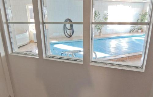 a view of a swimming pool through a window at Beautiful Home In Vessigebro With Sauna in Vessigebro