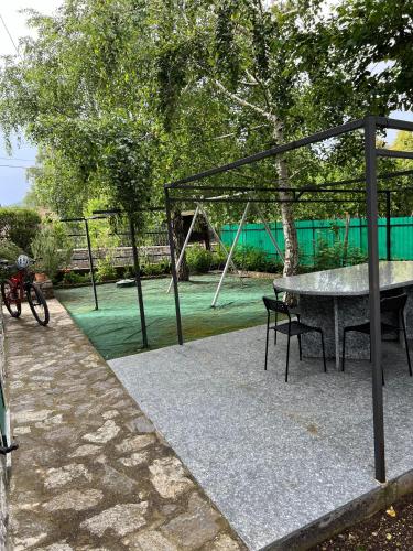 a park with a table and a swing set at Crosa Rosella in Bardineto